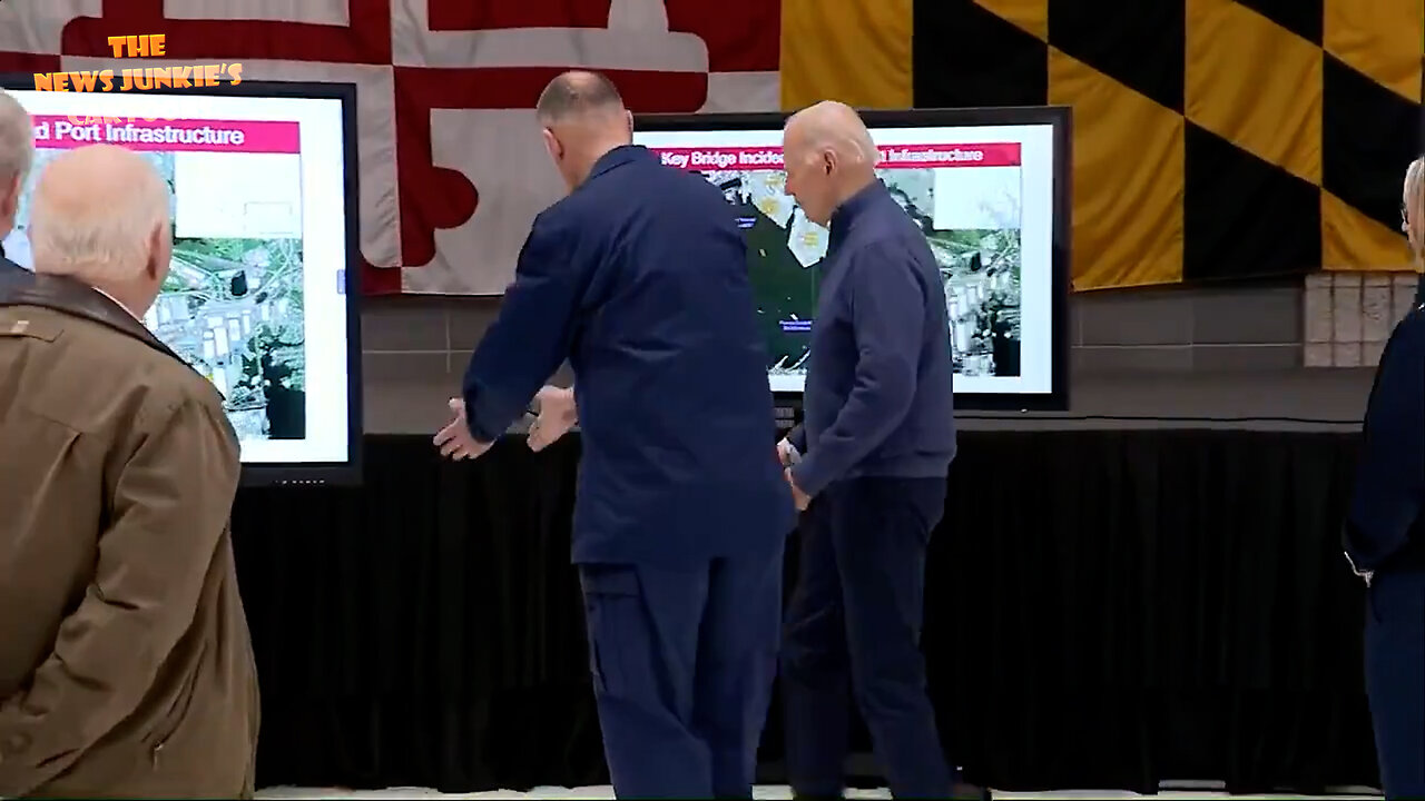 Joe goes to Baltimore to see some pictures of the collapsed bridge: "Do you want me right here?" His handler: "Yes, sir!"