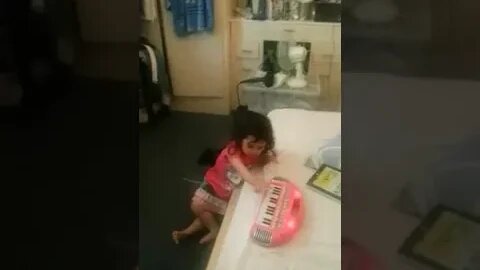 Super cute baby girl is dancing and giggles filling the room with joy