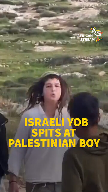 ISRAELI YOB SPITS AT PALESTINIAN BOY