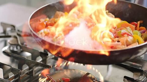 Slow motion shot of frying food into the pan including flaming. Slow motion 200fps ARRI Amira shot