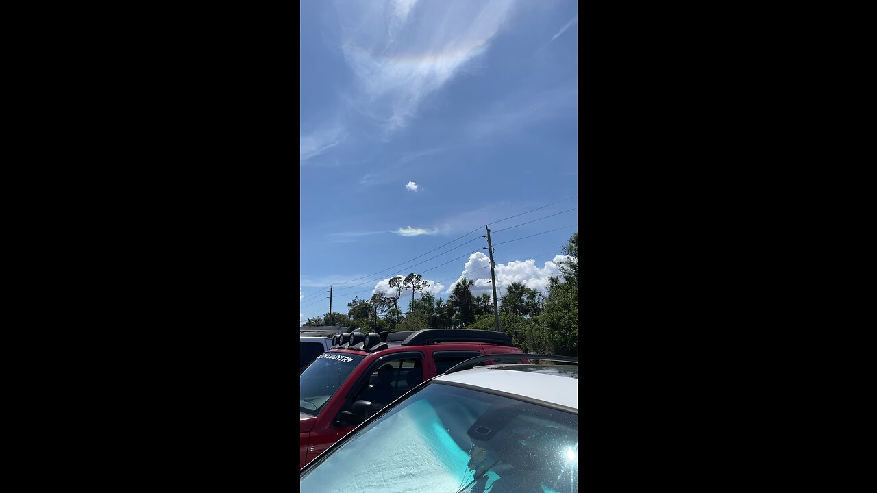 Sky with a tiny rainbow cloud