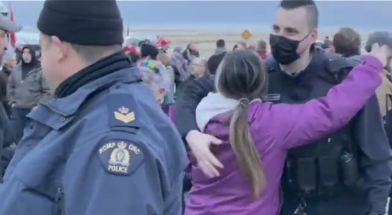 Police And Protestors Hug And Shake Hands