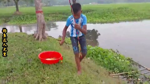 The little boy went fishing by the river and brought home big carp to improve his food +11