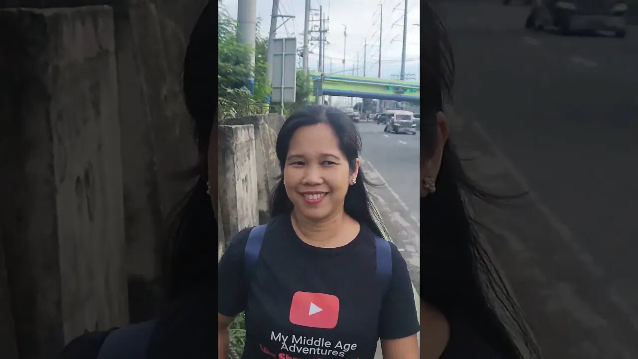 trees growing in the middle of the road way in Imus city Cavite Philippines