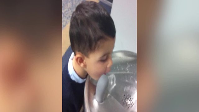 Funny Boy Tries To Drink Some Water From A Drinking Fountain