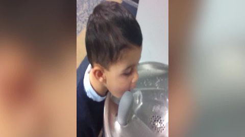 Funny Boy Tries To Drink Some Water From A Drinking Fountain