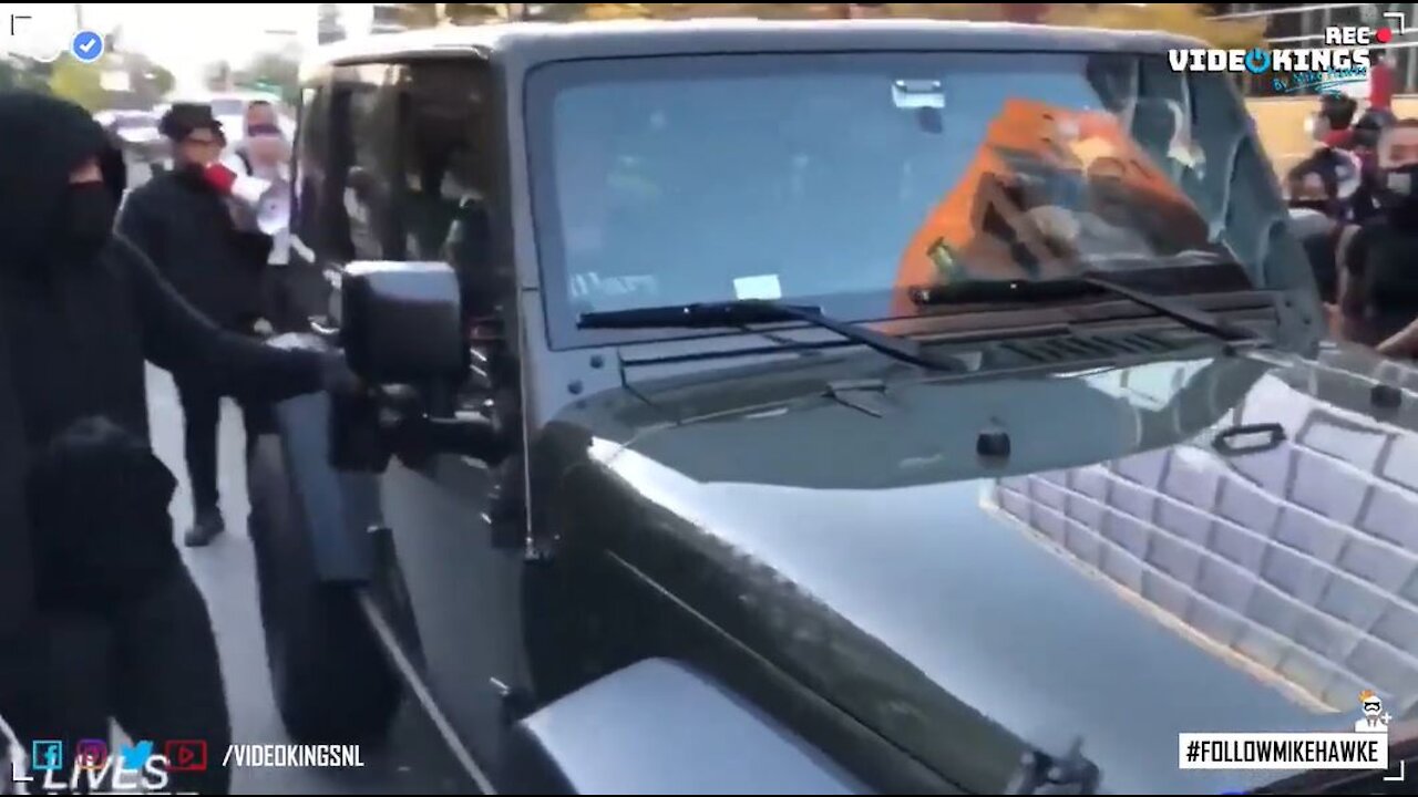 Aggressive ANTIFA-hooligan tries and fails to break car window. | #MillionMAGAmarch