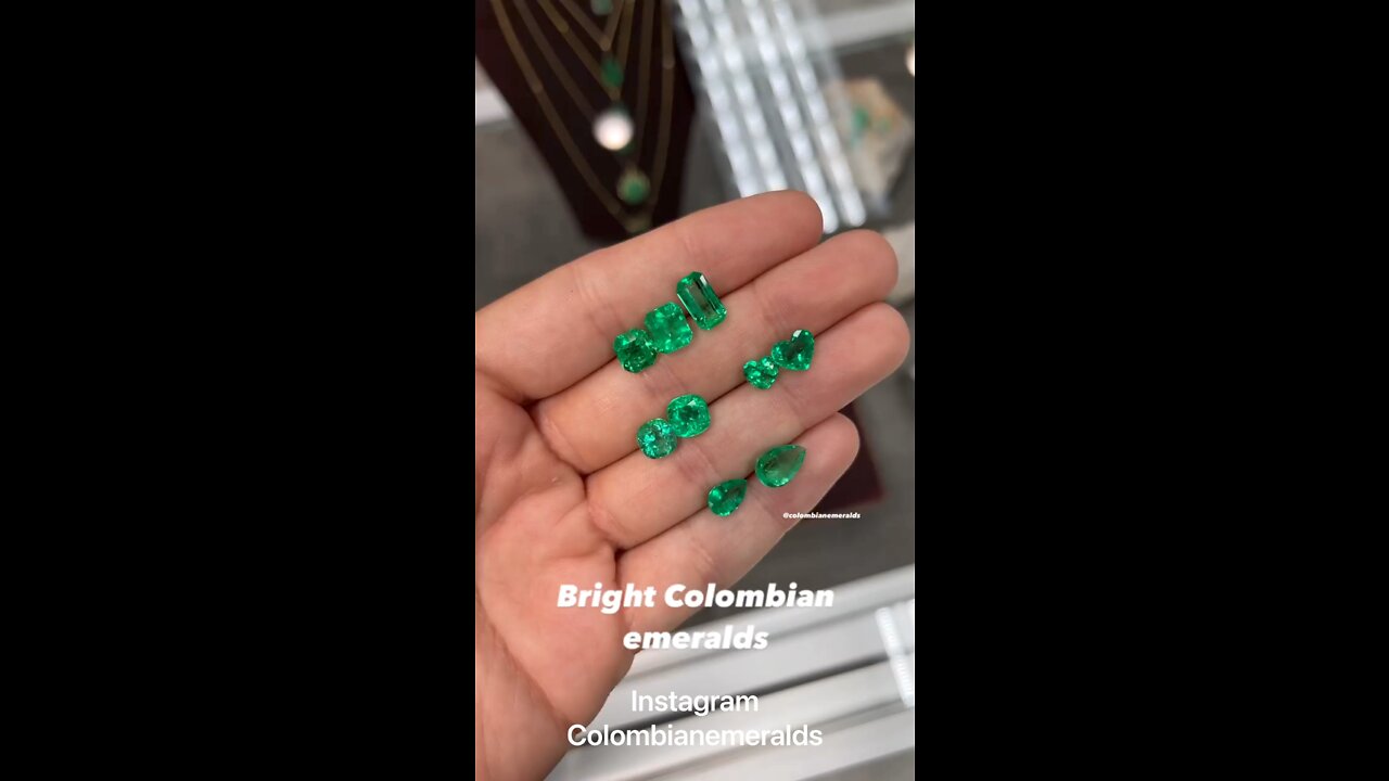 Mixed shapes bright apple green vivid minor oil Colombian emeralds for sale on hands