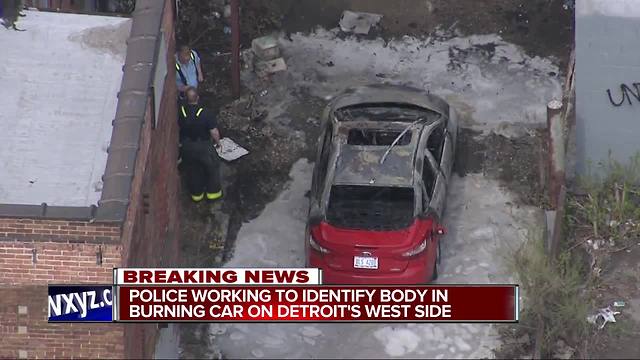 Police working to identify body in burning car on Detroit's west side