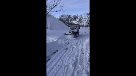 Breaking through snowdrift with snowblower