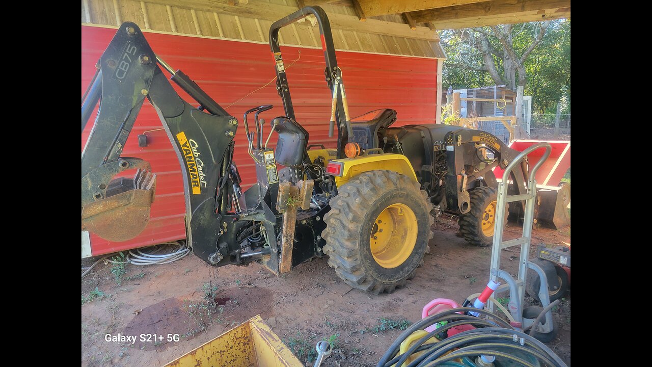 Working on the backhoe tractor