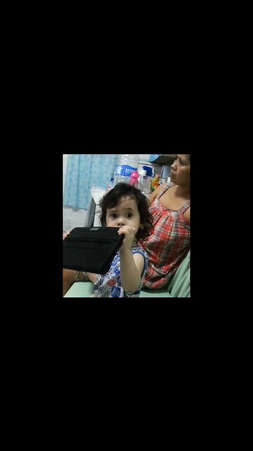 Sweet little baby girl does ipad with her grandmother