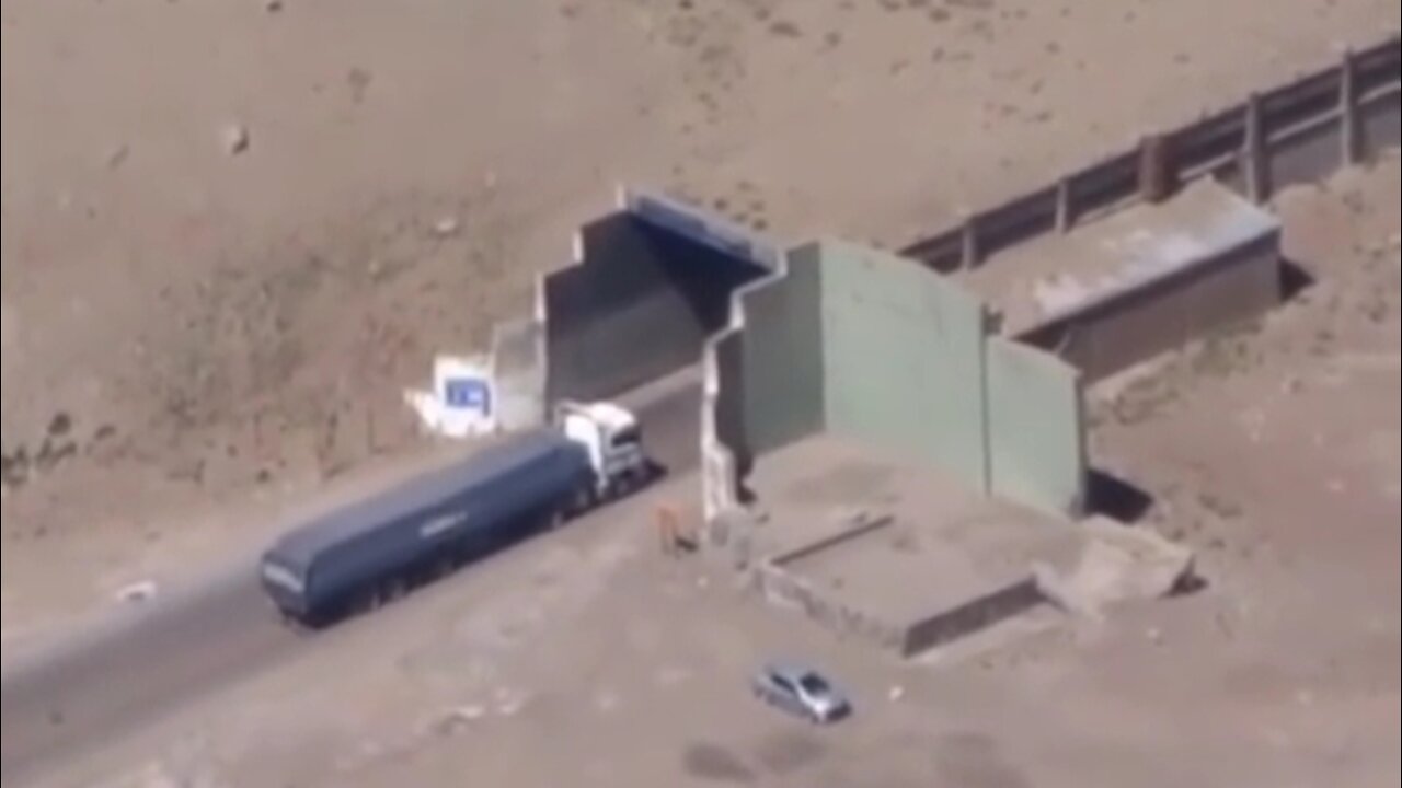 Container truck enters the tunnel that cuts through the mountain