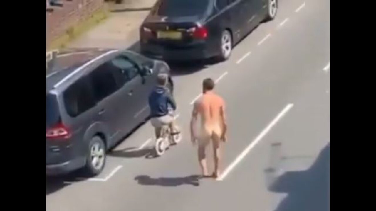 Crazy Naked man tries to attack dwarf riding a bicycle, maybe he got the vaccine. He needs Jesus!!