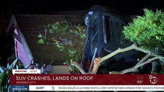 SUV crashes and lands on the roof of a home