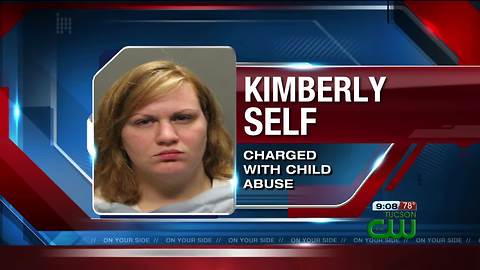 Woman arrested on charges of child abuse