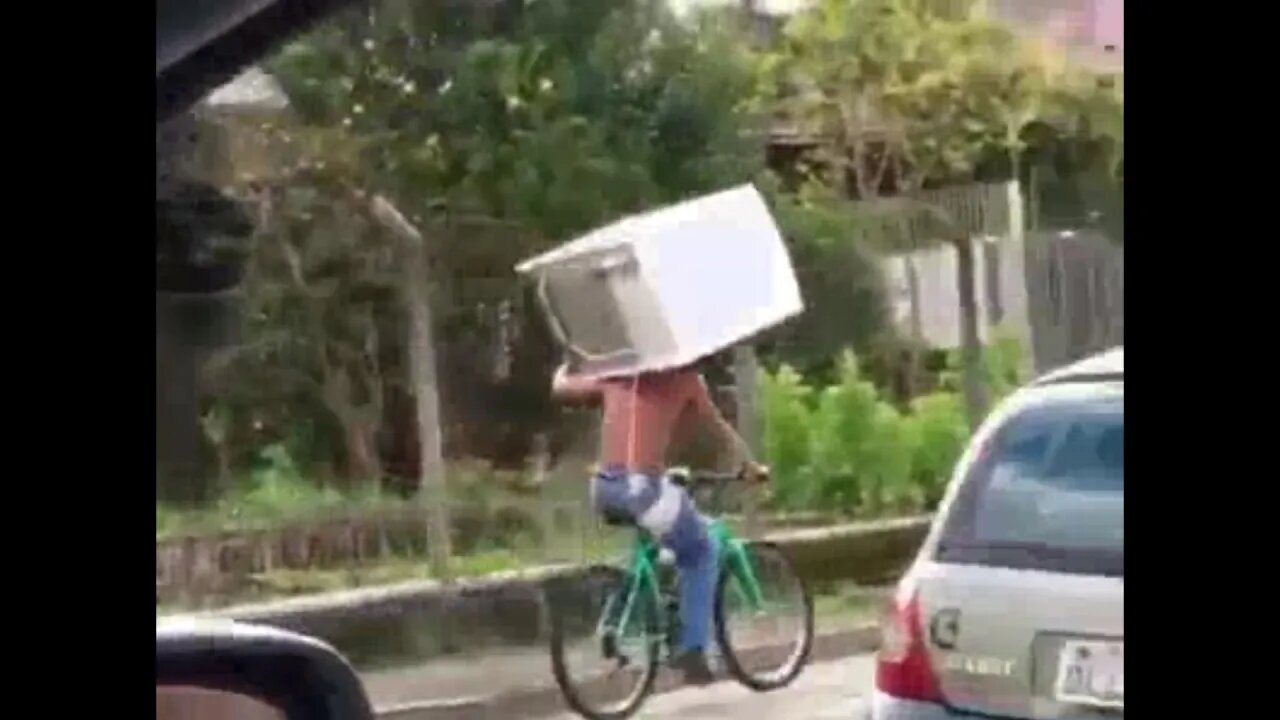 Man Carries a Fridge on a Bike