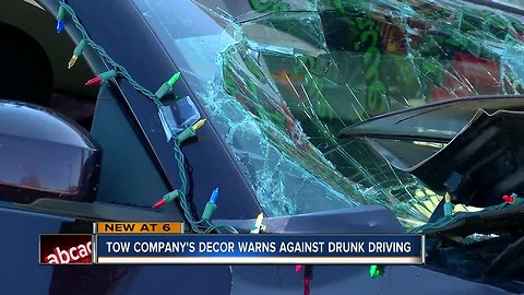Towing company hopes crashed car decoration will help save lives