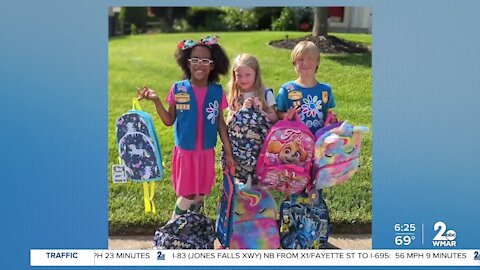 Girl Scouts collecting book bags