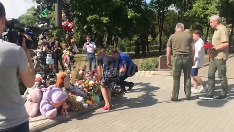 In Donetsk, flowers and toys are laid in remembrance of child victims of the conflict