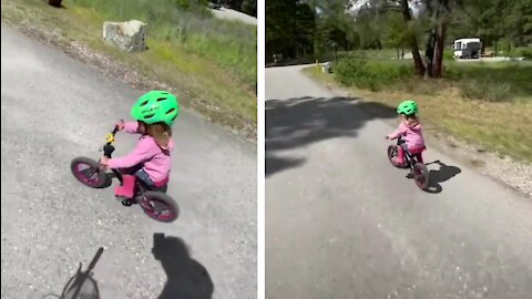 Toddler riding bike very fast amazed his dad