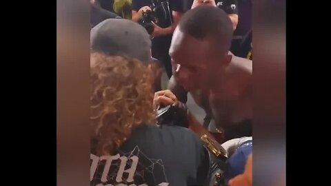 Israel Adesanya puts his belt on Boogerbeard