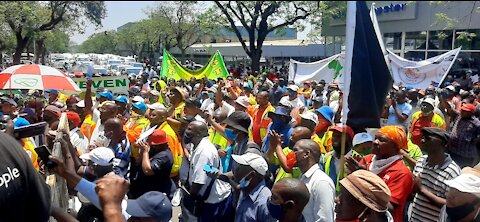 Members of the taxi industry make their way to the Union Buildings