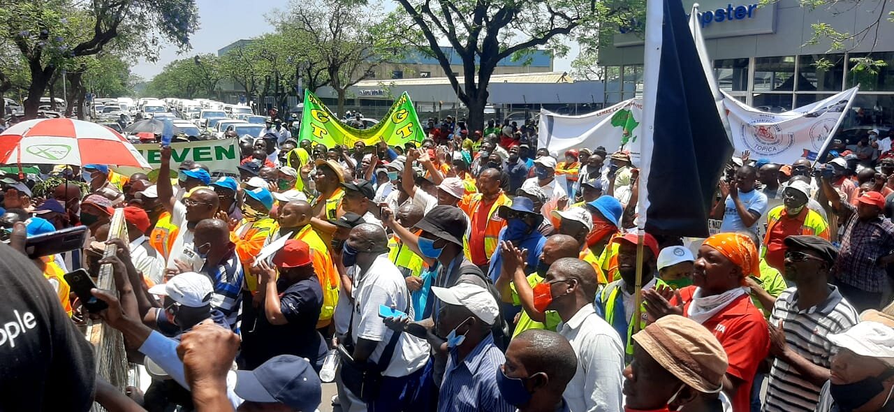 Members of the taxi industry make their way to the Union Buildings