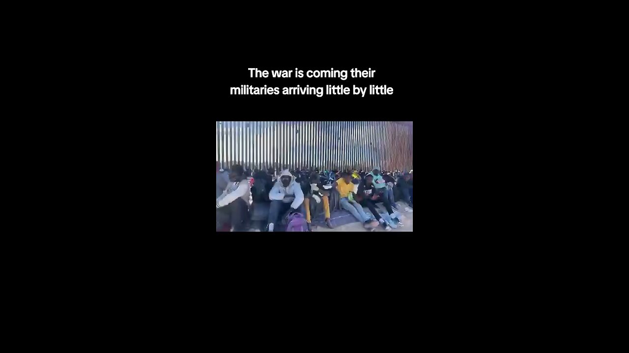 Military Aged Illegal Immigrants Line the Broken Border Wall