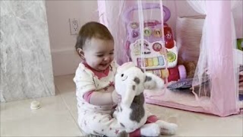 Baby adorable hugs her stuffed animal