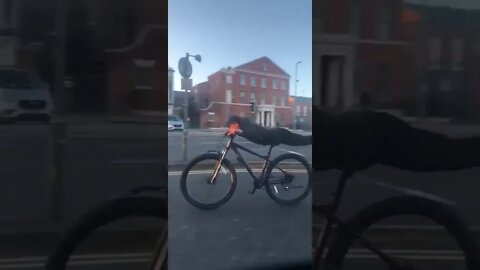 Man Superman Planks On Bike Going High Speed Down The Road