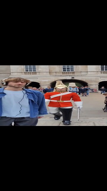 The man with the head phones had no idea the queen's guard was behind him #horseguardsparade