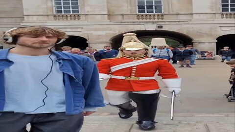 The man with the head phones had no idea the queen's guard was behind him #horseguardsparade