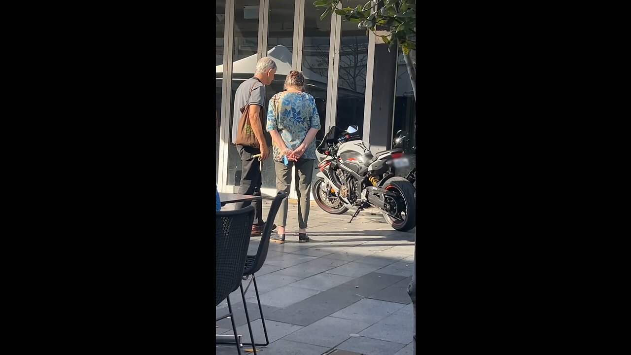 Old Couple Admiring Motorbike