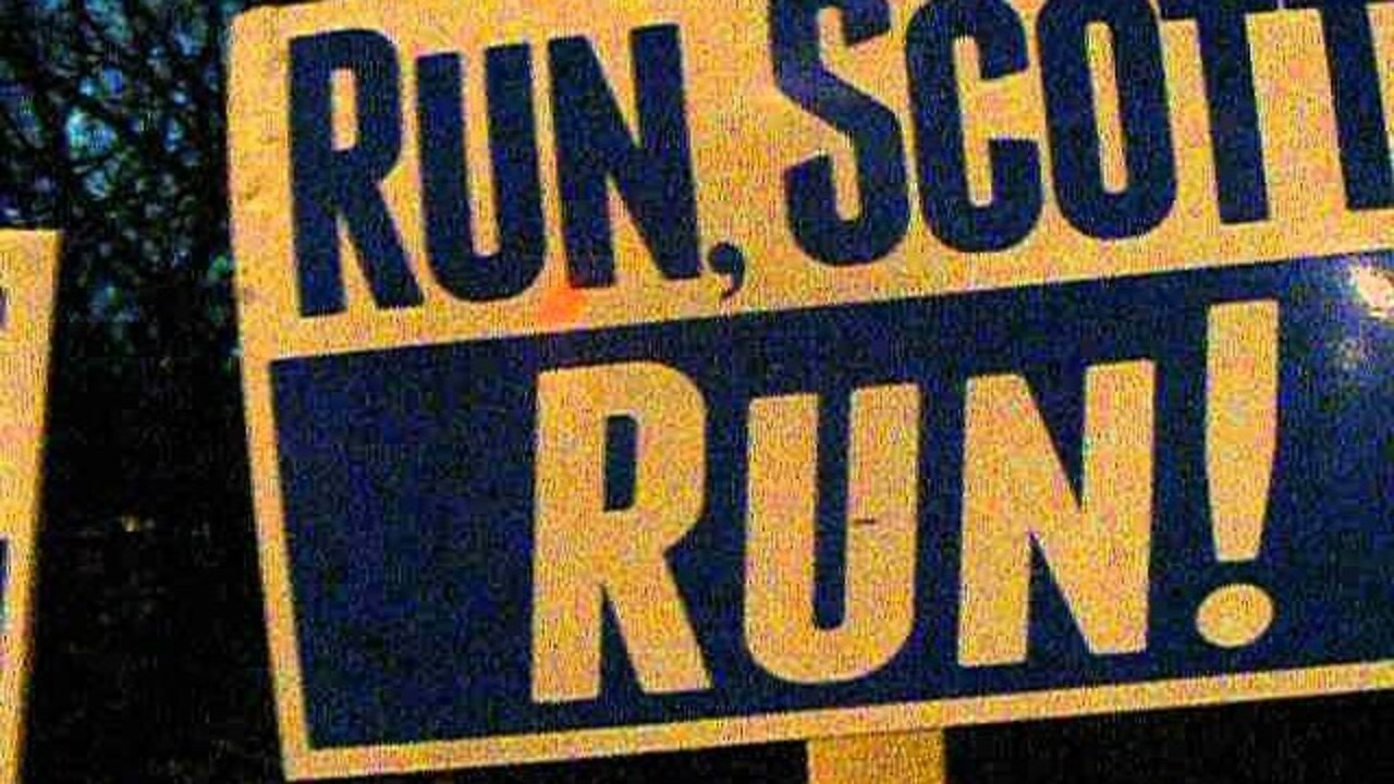 Scott brown in Nashua 12 19 13 Two Signs