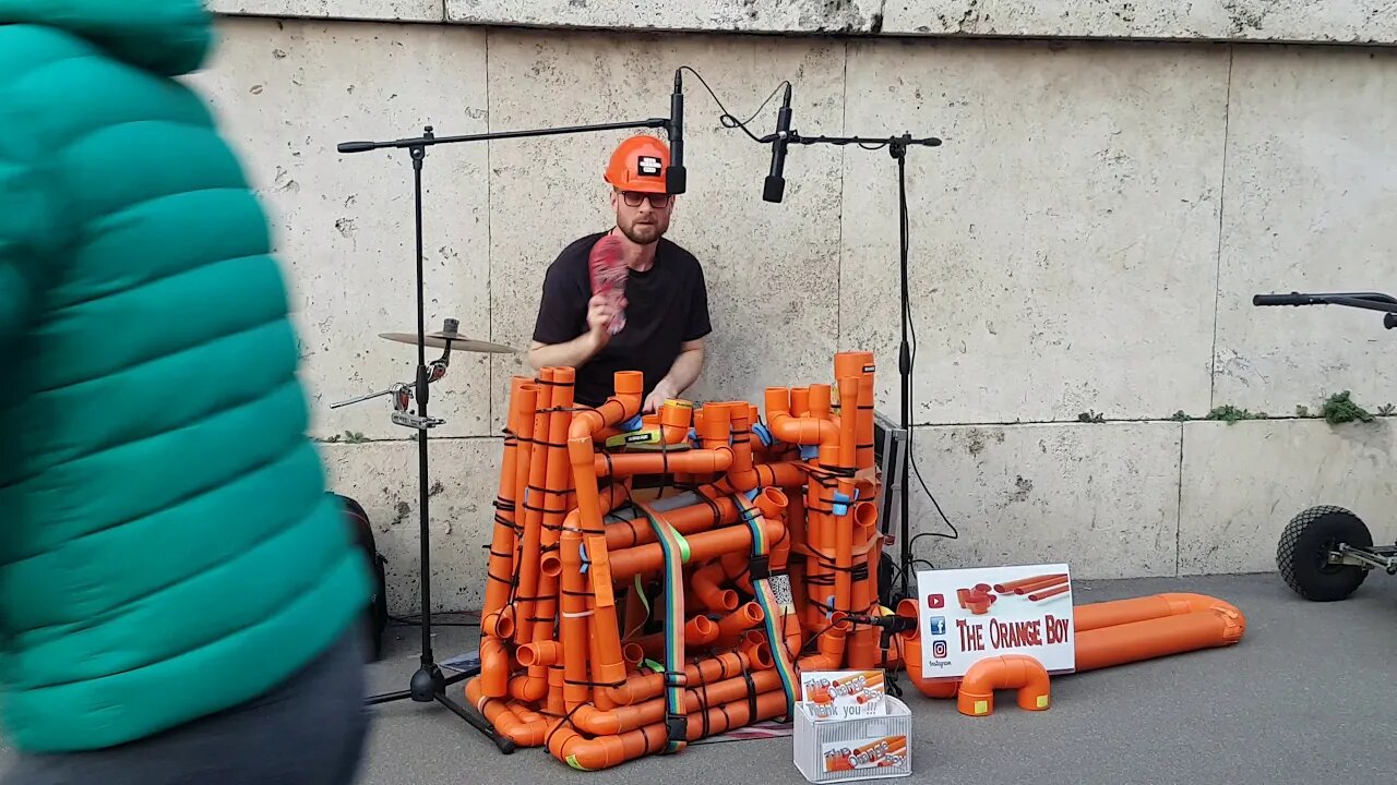 The man who drum beat with slippers and tubes The orange boy