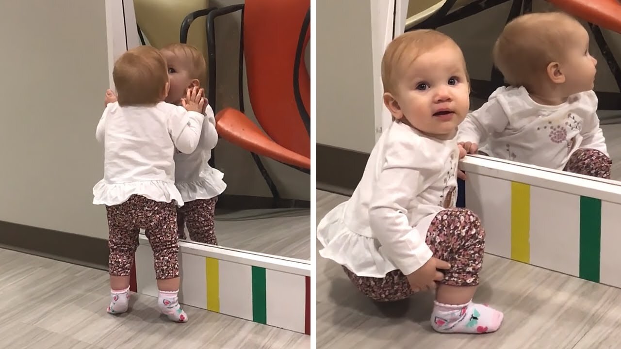 Baby girl sees miror