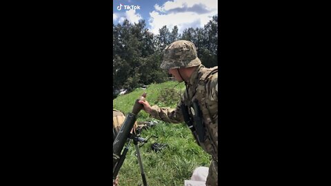 Ukrainian army fighter with Nazi totenkopf on his chest learns how to use a mortar