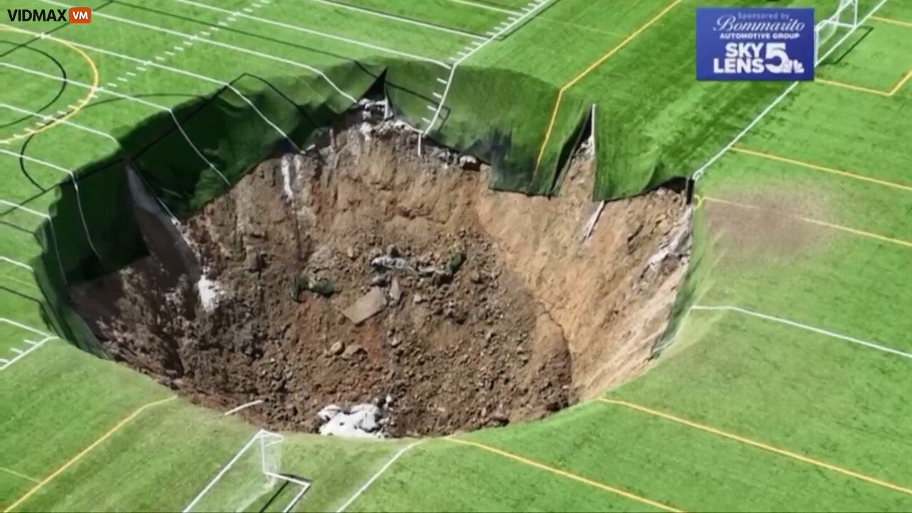 Insane Footage Shows The Earth Swallowing A Huge Chunk Of A Soccer Field Along With A Light Pole