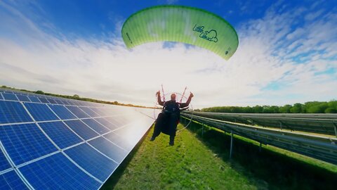 Paramotoring cruising low over Solar Farm