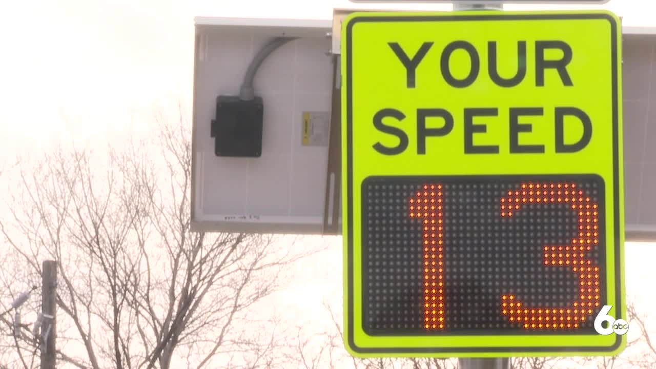 high school seniors help install new speed limit signs