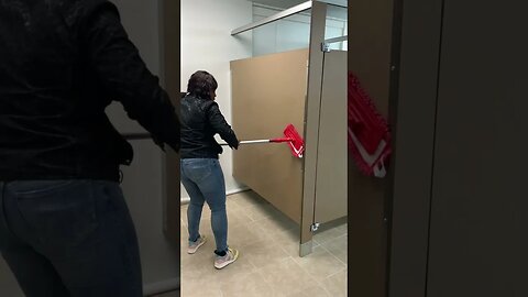 Students learning how to use wall scrubbing tools and skills during Restroom class