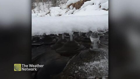 Secret ice pillars hold the winter snow above the river