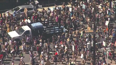 Denver police hand out water bottles to marchers Sunday