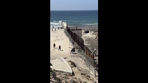 Illegal aliens rip down a fence to cross the border in San Diego Ca.