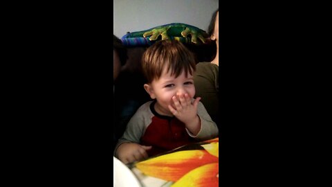 Eating popcorn and watching Hey Bear with mommy and daddy.