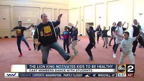 The Lion King cast members dance with local kids