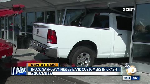 Truck narrowly misses bank customers in crash