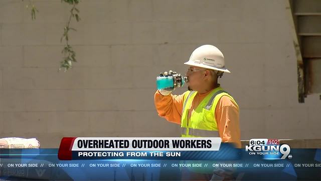 Outdoor workers protecting themselves from the heat, avoiding dehydration