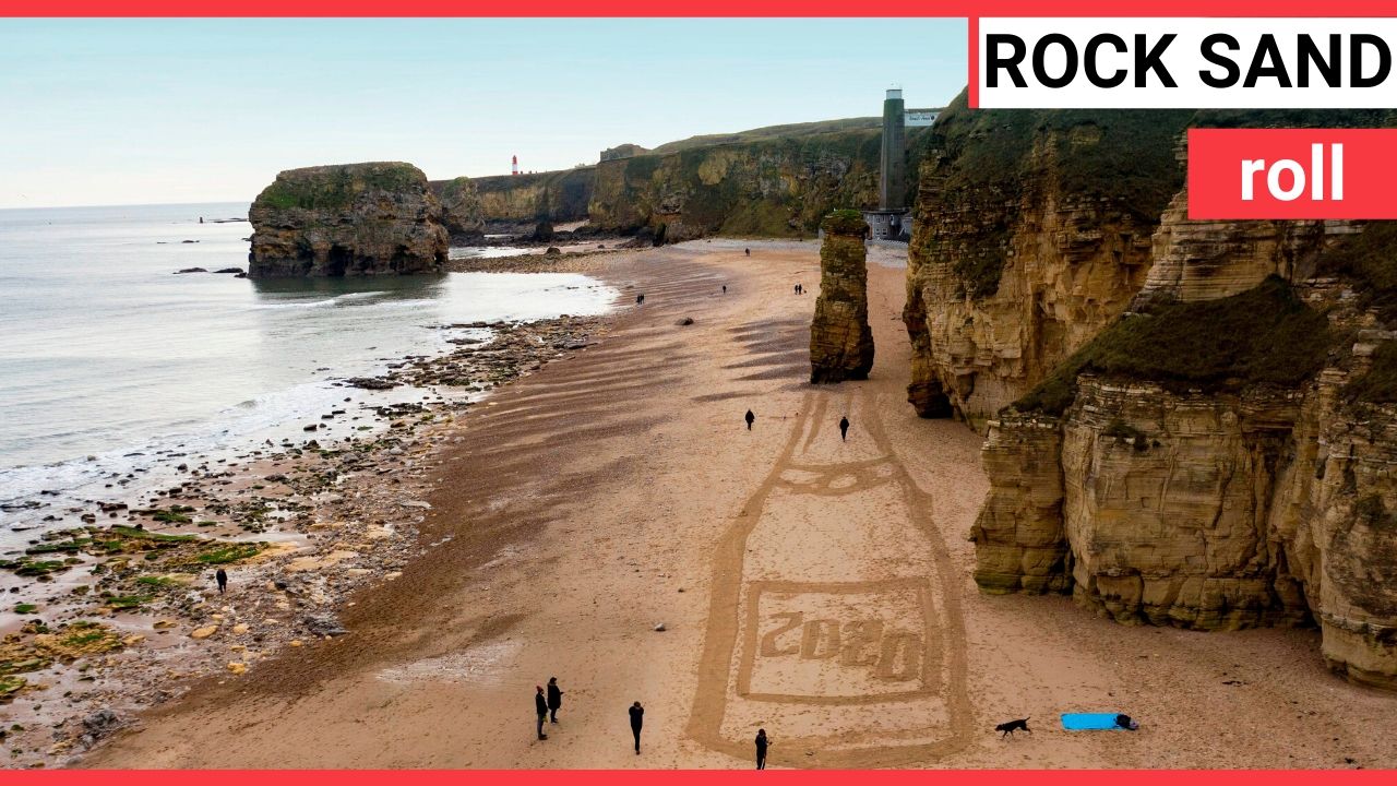 Beach artist transforms 250million year-old rock stack into giant bottle of champagne